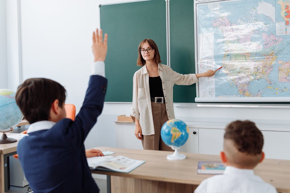 A teacher explaining geography with a map to students in a classroom setting